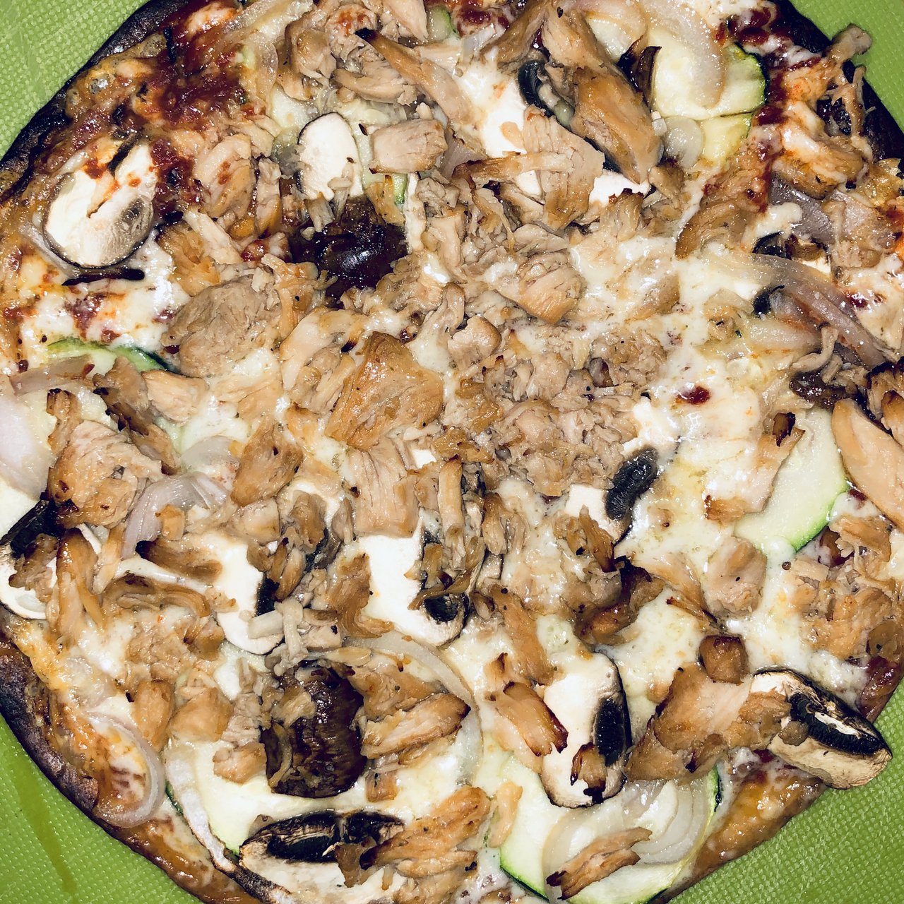 A home-made pizza from above — chicken, mushroom and courgette